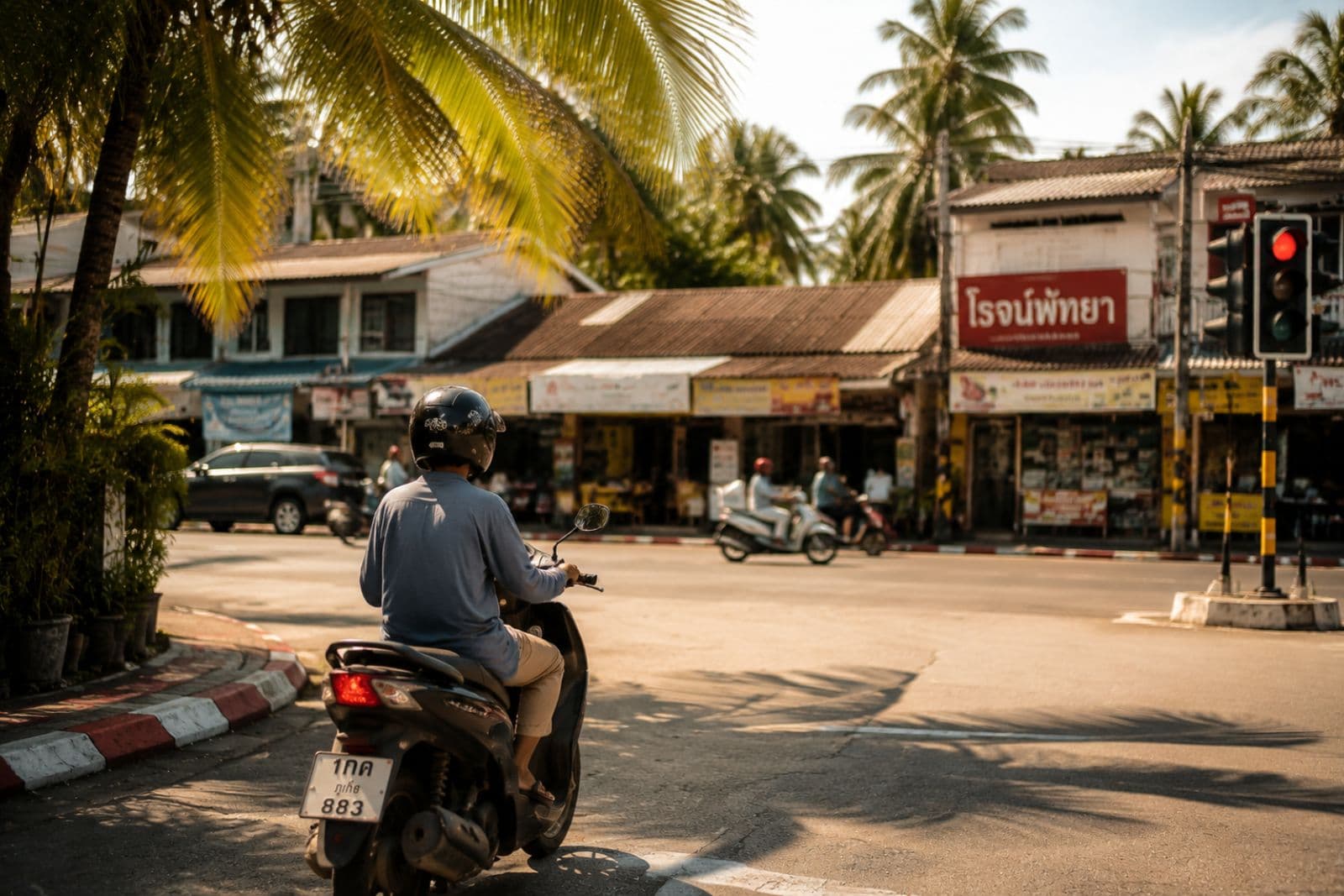 Scooter at intersection with Thai signage